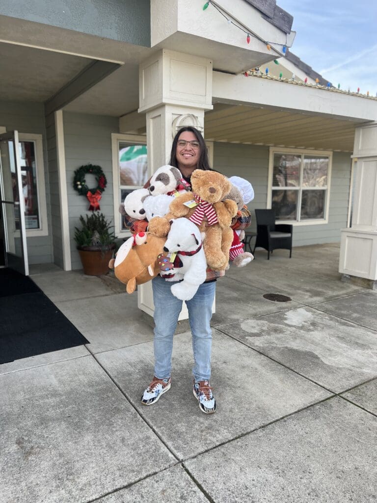 Andrew holding stuffed animals