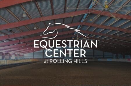 Inside equestrian center with Equestrian Center of Rolling Hills logo
