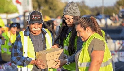 Members distributing food at food drive event